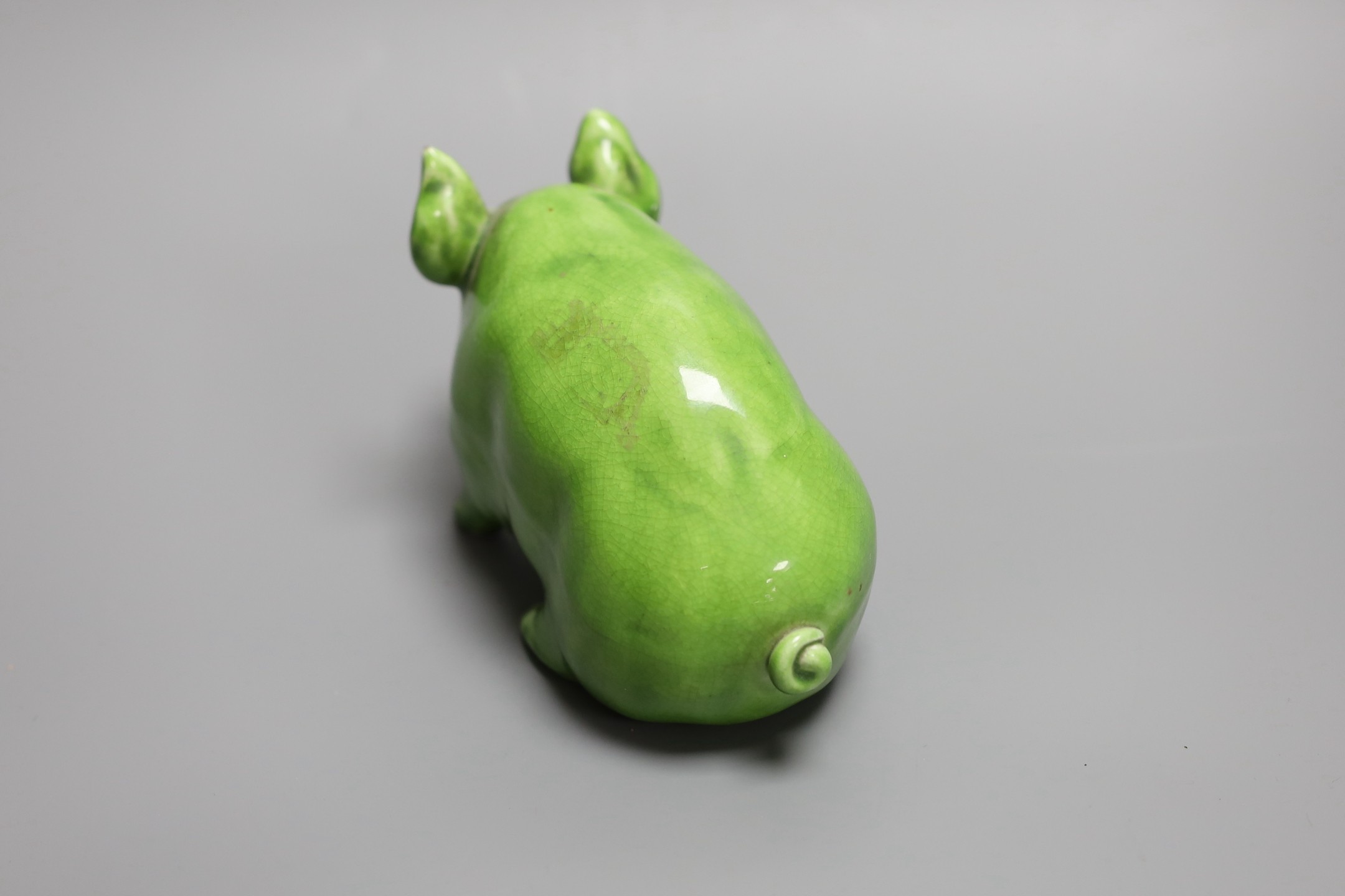 A Wemyss ware pig, decorated in lime green glaze and impressed to the base Wemyss ware RH & S, for Robert Heron & Son of Fife, 16.5cm long, 10cm high.